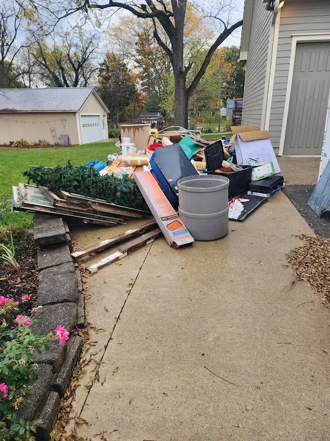 Dumpster being loaded with debris for Roofing Dumpster Rental in Difficult Run